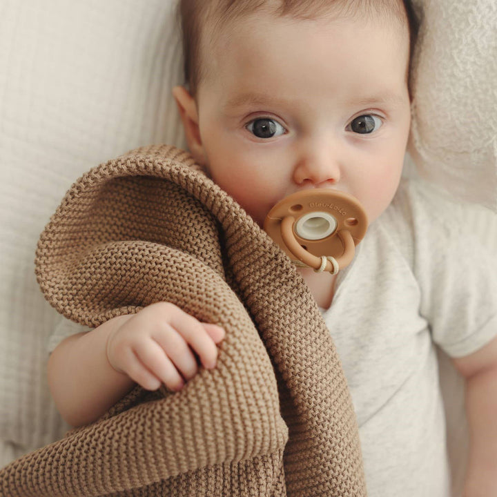 Baby with Pacifier wrapped in the Hunter Green Bleu La La Heritage 100% Organic Cotton Knitted Swaddle