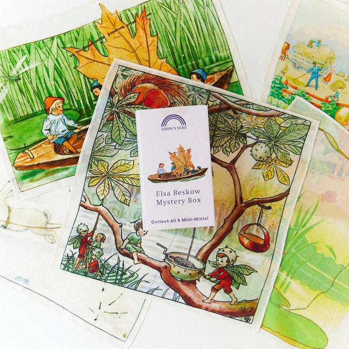 Mini silks fan out, showcasing the whimsical artwork found in the Elsa Beskow Mini Mystery Playsilk