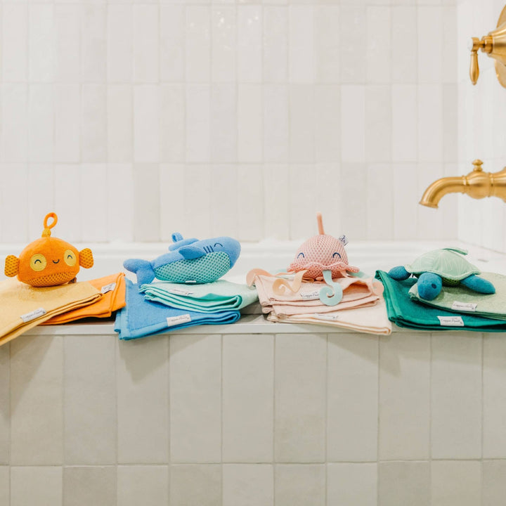 Plush bath toys near bathtub, baby bath toys for cozy and playful bath time routines