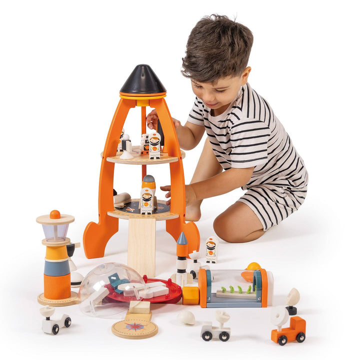 Child sorts tiny astronauts and a lunar vehicle from the Cosmic Rocket Set during pretend play