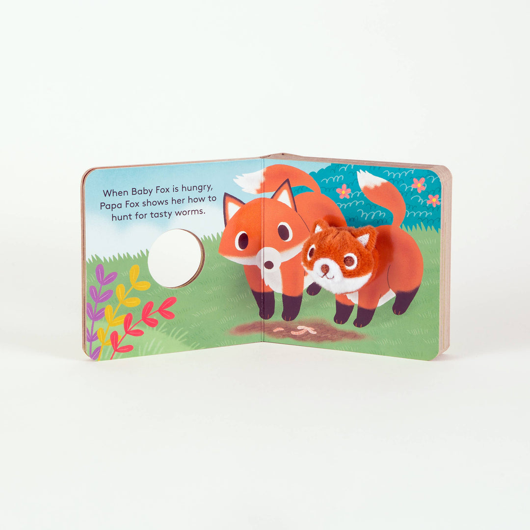Two foxes illustrated together in a floral spread from Baby Fox Finger Puppet Book