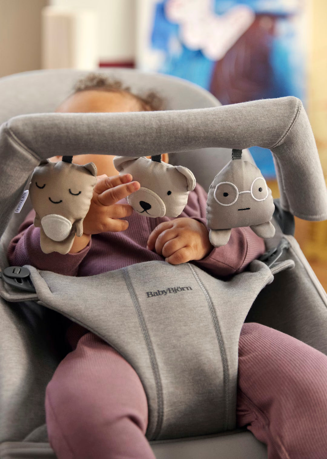 BabyBjorn Bouncer Toy harness and buckle close-up showing 5-point safety system for infant