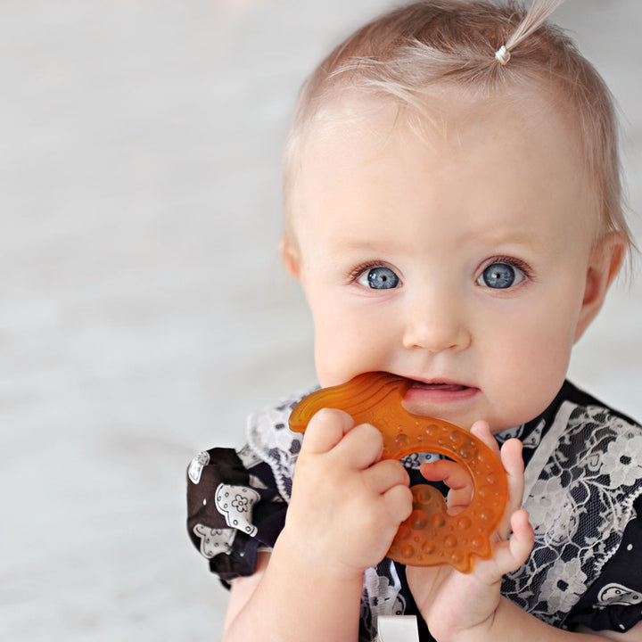 Infant holding non-toxic Caaocho fish teether for teething relief