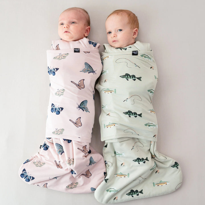Designed with movement in mind, the Kyte Baby Sleep Bag Swaddler XS in Fishing works as a soft sleep sack baby essential