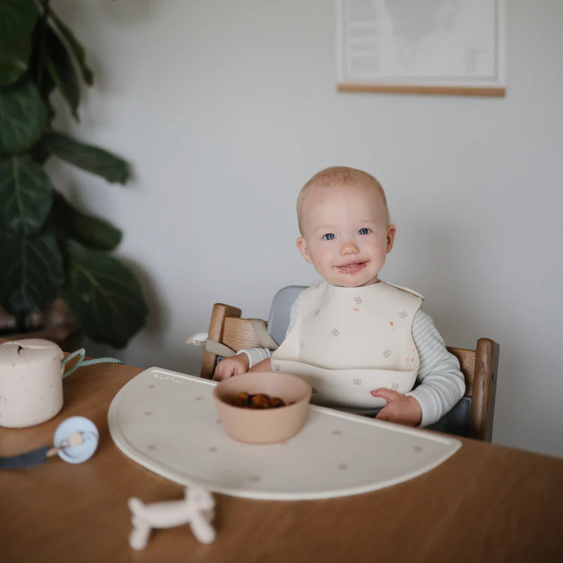 Mushie Placemat in Pretzel A delightful pretzel design that brings a touch of fun and whimsy to any table