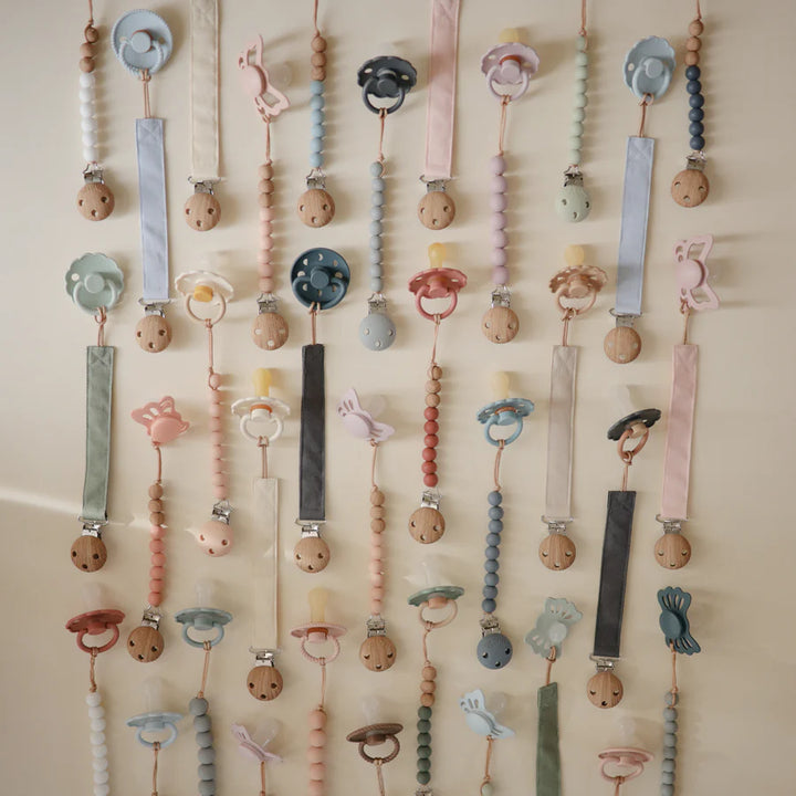 Elegant Collection of Mushie Linen Pacifier Clips designed for secure and cute pacifier clips.