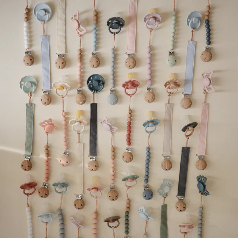 Elegant Collection of Mushie Linen Pacifier Clips designed for secure and cute pacifier clips.