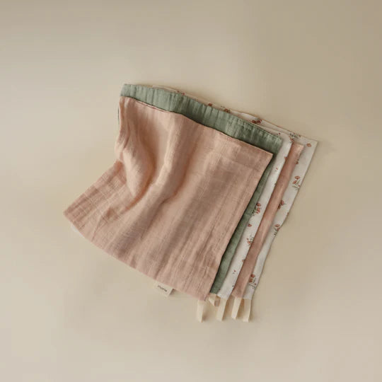 Mushie Muslin Cotton Washcloth 5-Pack November flat lay - stacked organic cotton washcloths in coordinating floral prints