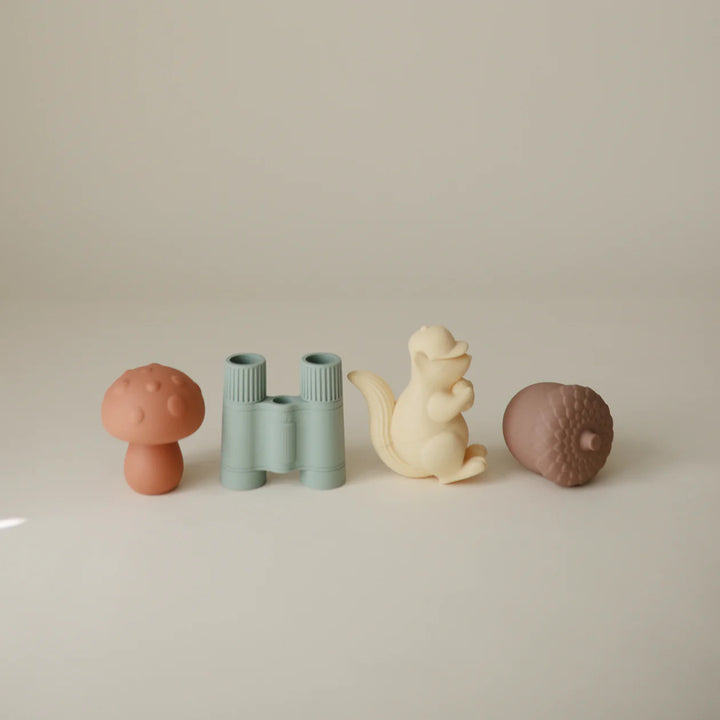 Mushie Nature Bath Play Set flat lay - four nature-themed silicone bath toys on minimal neutral background