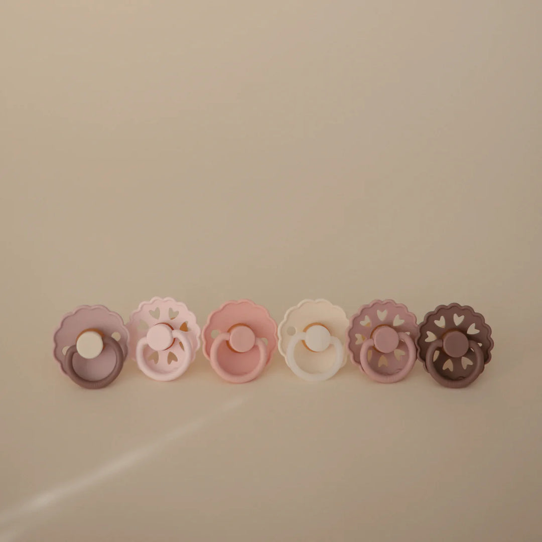 FRIGG Blooming Love rubber pacifier 6-pack flat lay - blush and rose latex soothers on white background