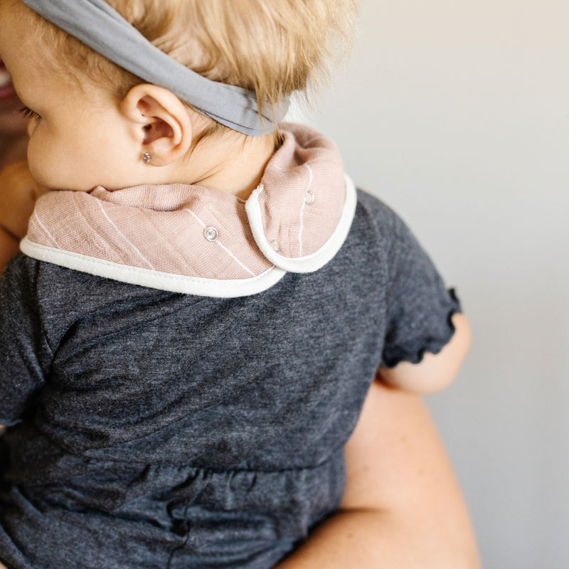Rear view of Little Unicorn Cotton Muslin + Fleece Bandana Bib 4 Pack - Mauve Stripe showing fleece back, cozy and absorbent baby bib.