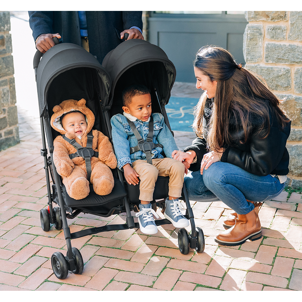 parents walking with uppababy g-link double stroller