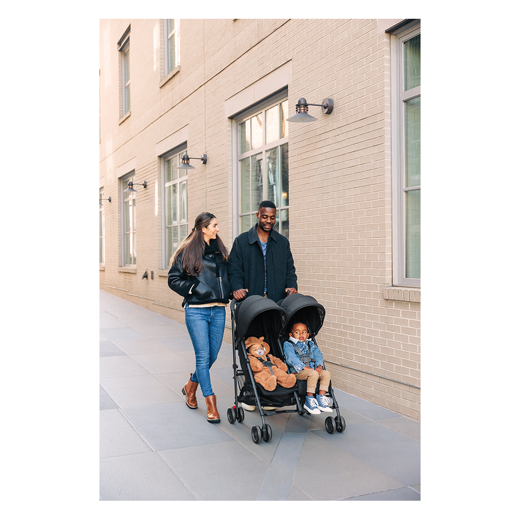 parents strolling with uppababy glink double stroller