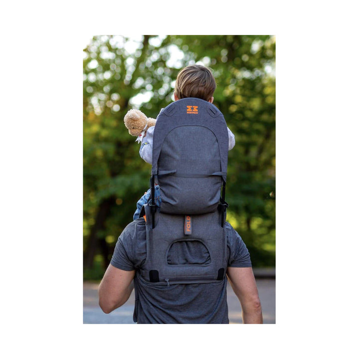 Child sitting in the grey/orange shoulder carrier