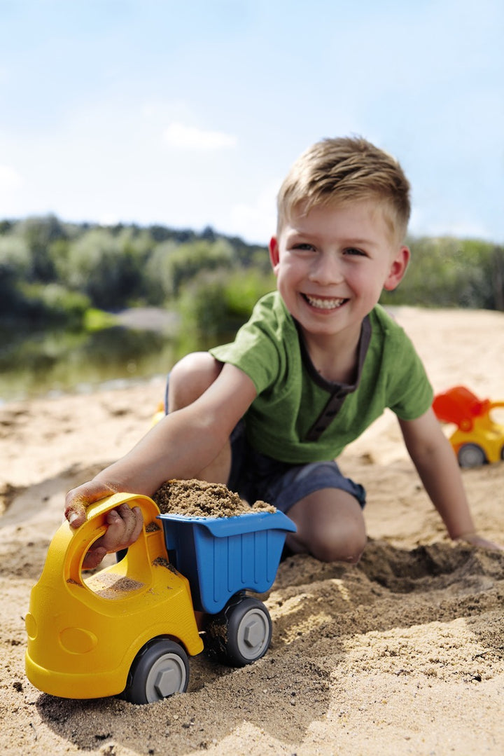 Yellow Baudino Dump Truck by HABA, built for sandbox adventures.