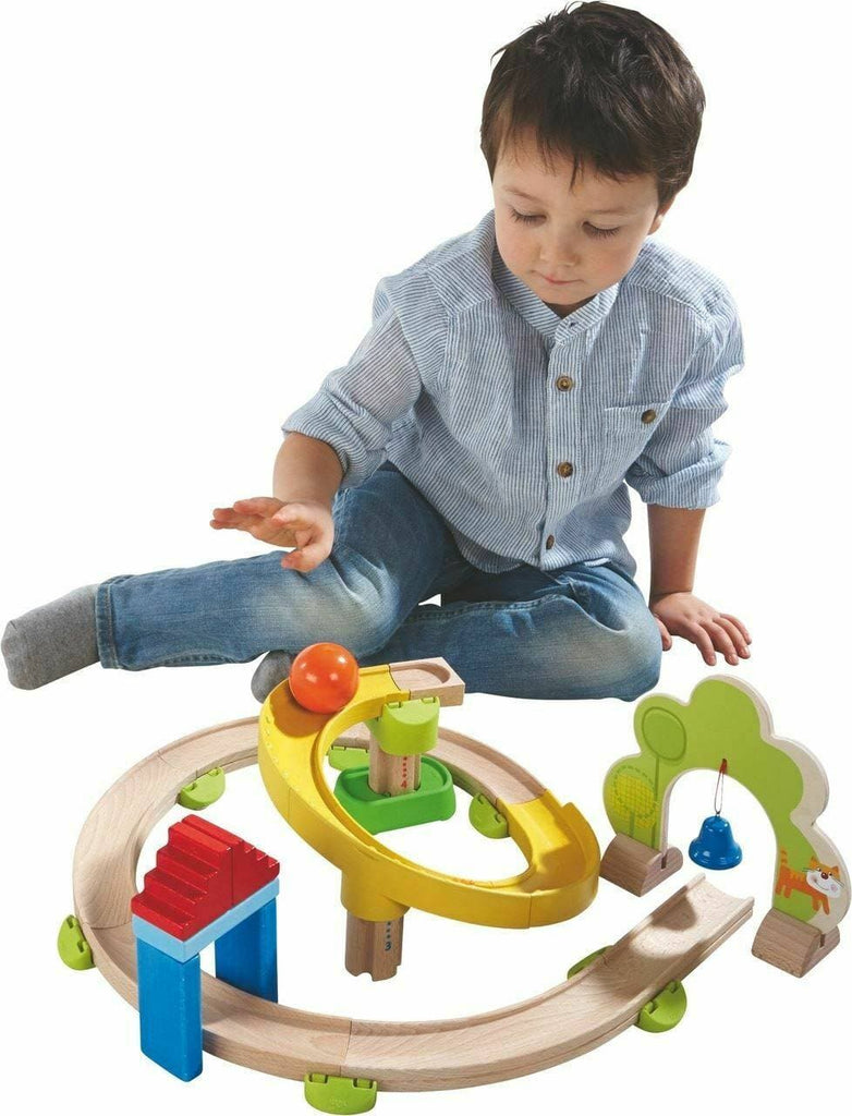 boy playing with haba spiral track starter set with roller ball