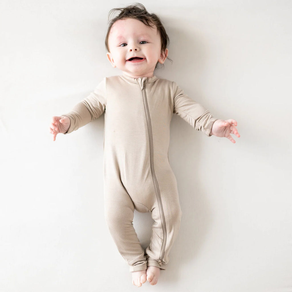 Happy baby wearing adorable Zipper Romper in the shade Khaki.