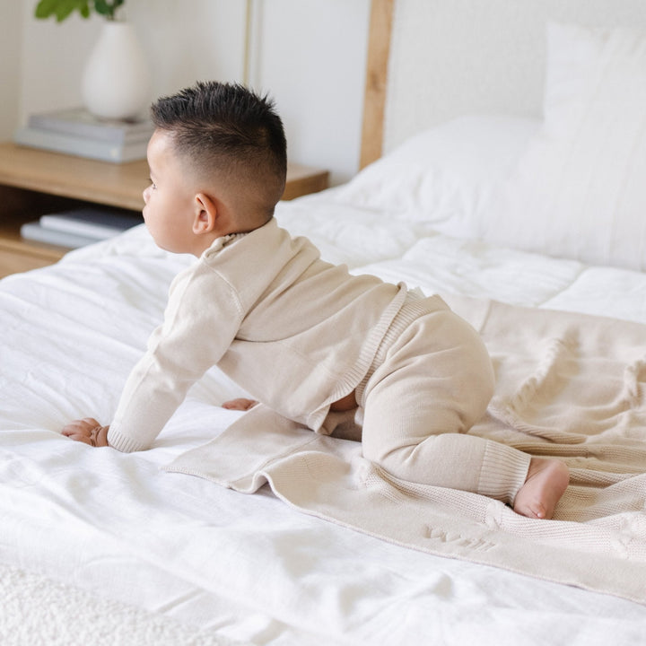 Let bedtime feel special with the Tan Saranoni Heirloom Cotton Knit Set, a soft and soothing baby pajama set.