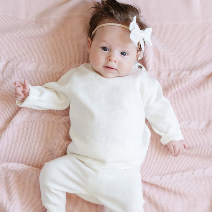 Made for everyday comfort, the Cream Saranoni Heirloom Cotton Knit Set blends luxury and practicality in baby clothing.
