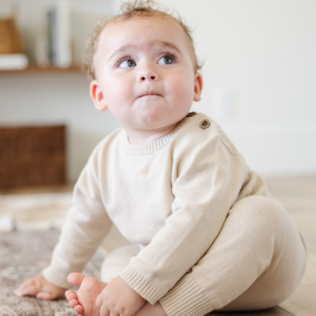 Bring effortless charm to your nursery with the Saranoni Heirloom Cotton Knit Set in Tan, a newborn essential.