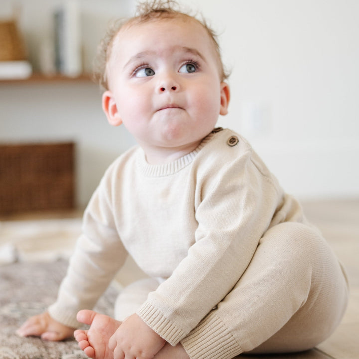 Bring effortless charm to your nursery with the Saranoni Heirloom Cotton Knit Set in Tan, a newborn essential.