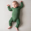 Baby wearing the comfy Kyte Zipper Romper in the color Hunter.