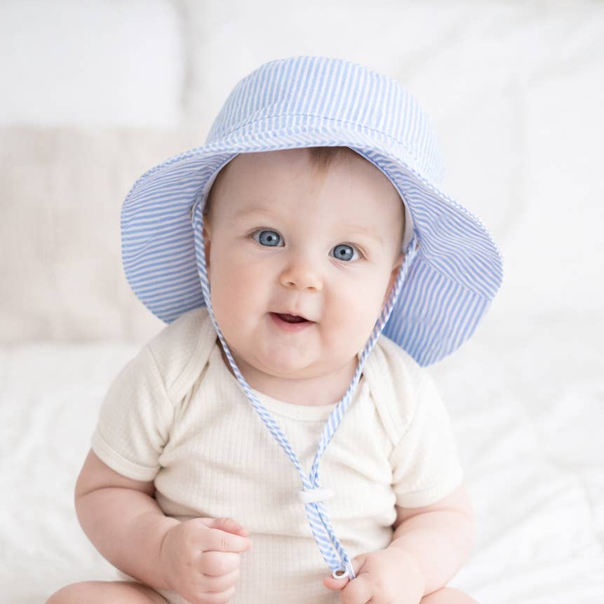 baby wearing hugg a luggs sun safe stripped toddle and baby bucket hat 
