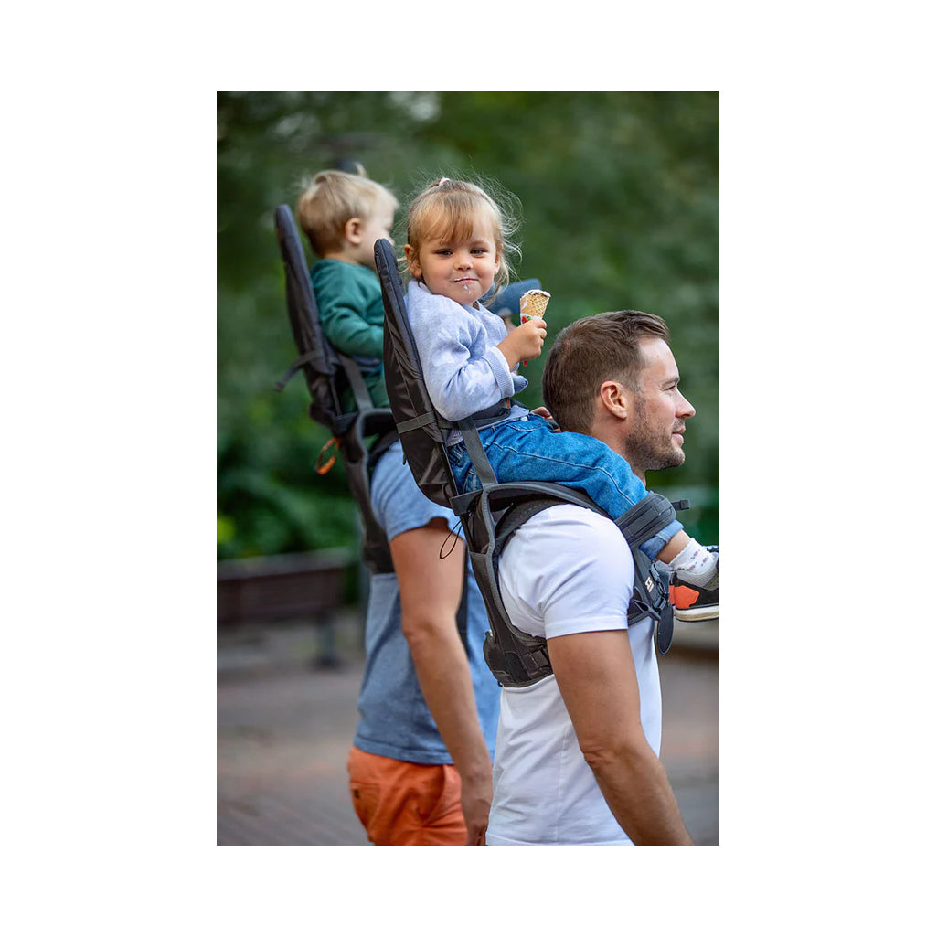 Child eating icecream in the grey shoulder carrier