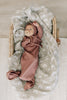 Baby laying in the organic cotton ribbed knot gown by Mebie Baby