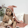 infant in hooded towel for bathtime