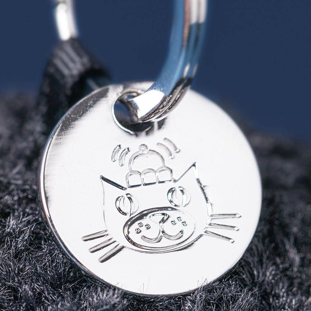 Jellycat Amuseables Black Hole Bag Charm close up silver charm tag detail cosmic themed plush accessory collectible Jellycat bag charm