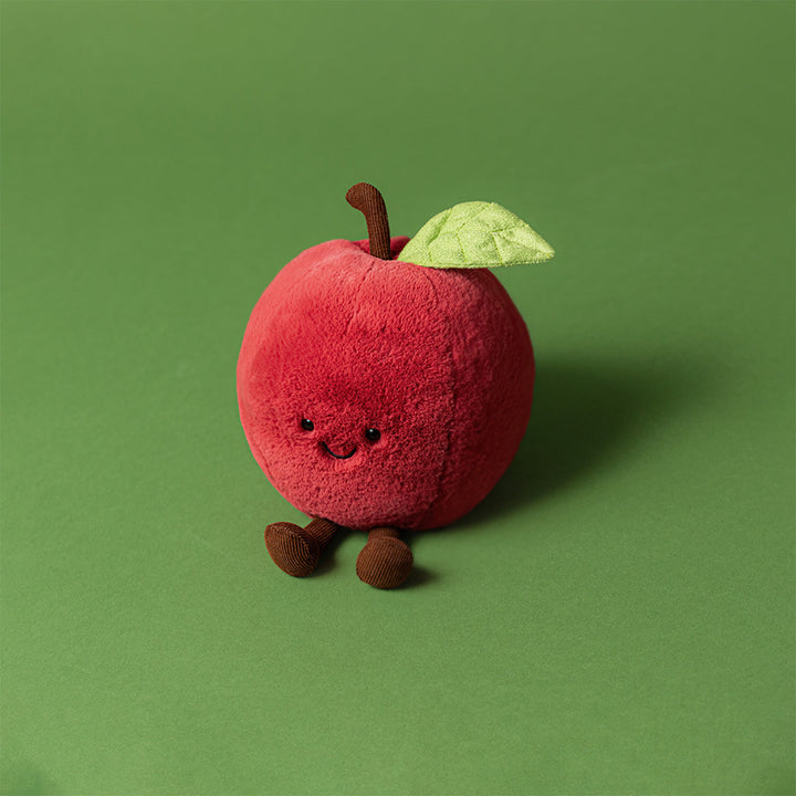 Jellycat Amuseables Apple plush toy shaped like a red apple with a green leaf on a green background