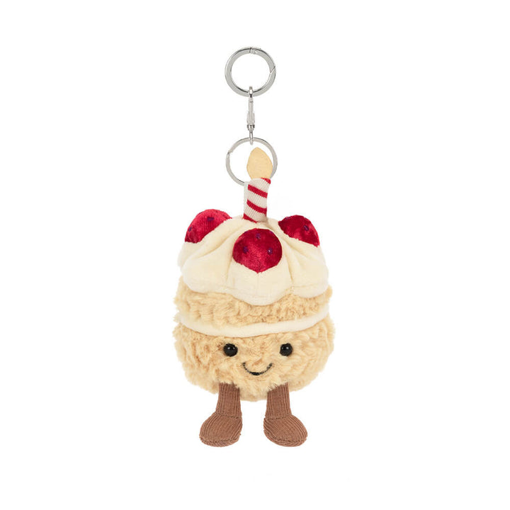 Smiling Jellycat cake keychain front view, Amuseables Birthday Cake Bag Charm with frosting and cord legs