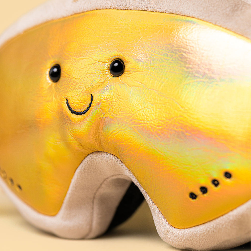 Close-up of smiling face on iridescent gold lens -- Jellycat AS2SKGO Ski Club Goggles Amuseables plush