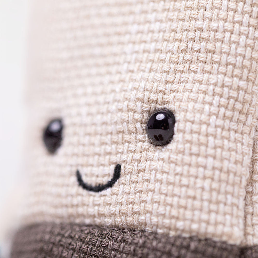 Close-up smile on Jellycat Steepy Tea Bag, woven texture Amuseables food plush A4TEAB
