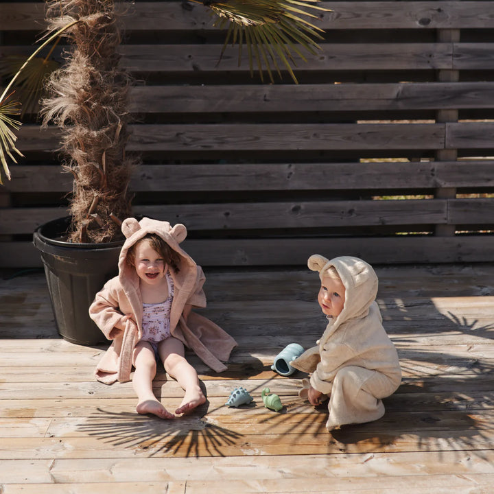 children on vacation playing with non toxic mushi bath toys at beach board walk 