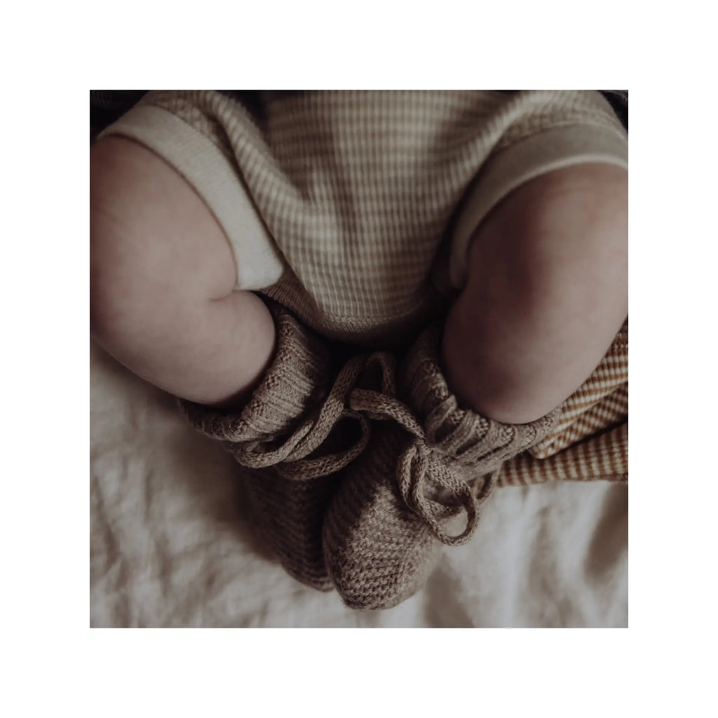 infant wearing knit infant booties