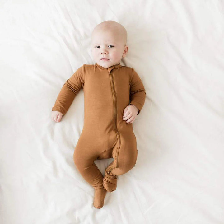 Bamboo footie pajamas in Nutmeg by Kyte Baby provide warmth and ease with a smooth zipper closure.