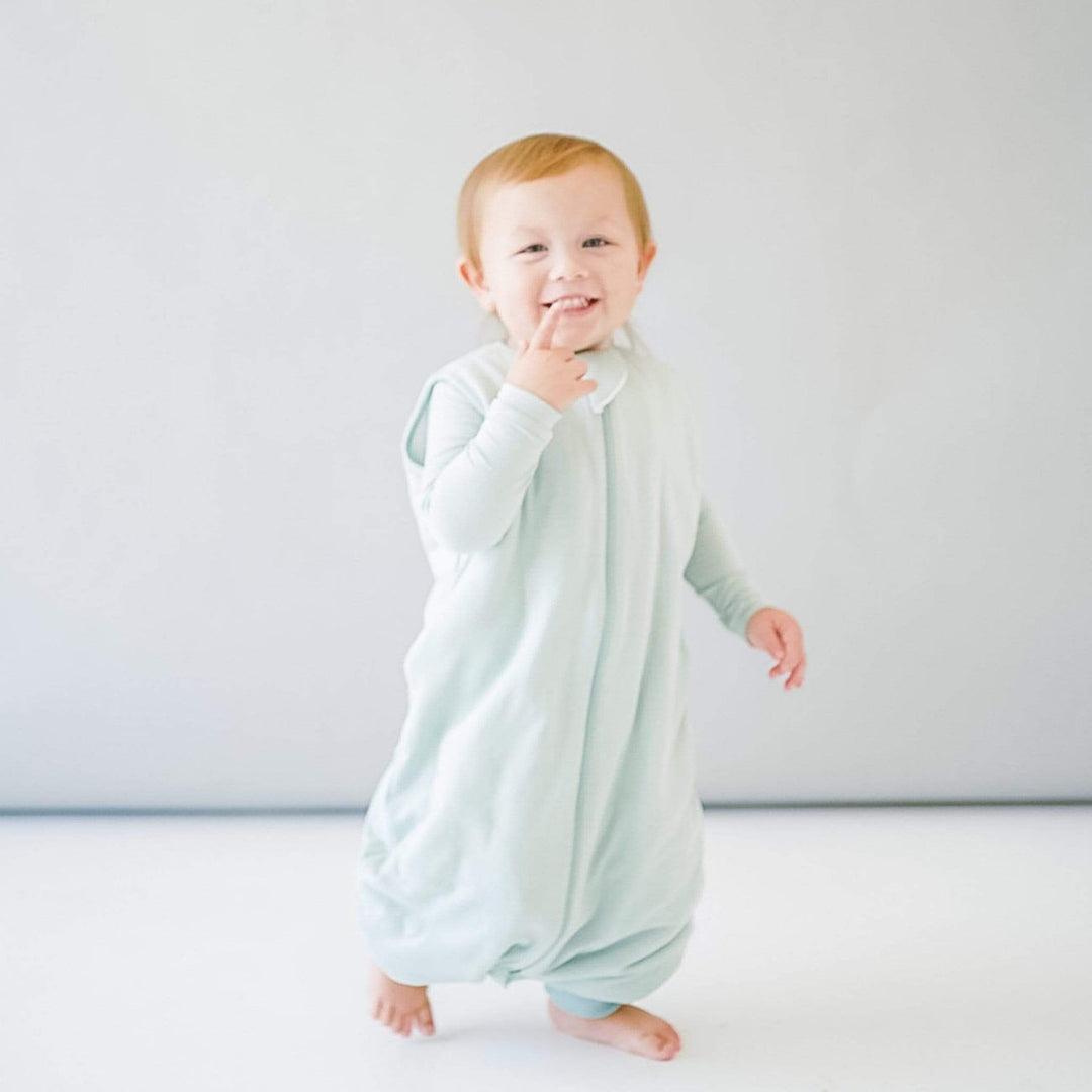 baby in sage green baby sleep sack Kyte Baby