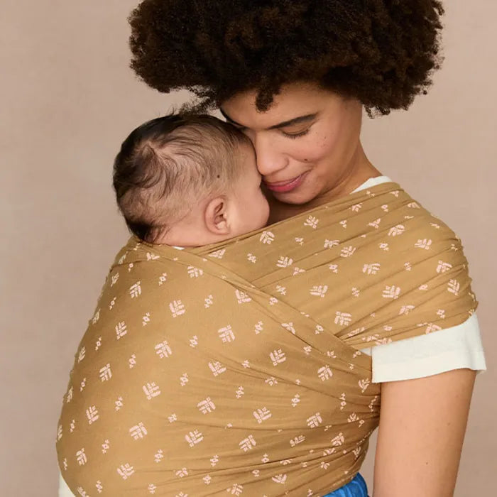 Everyday moments are made easier with the Ergobaby Aura Baby Wrap in Camel Harvest, a must-have baby wrap.
