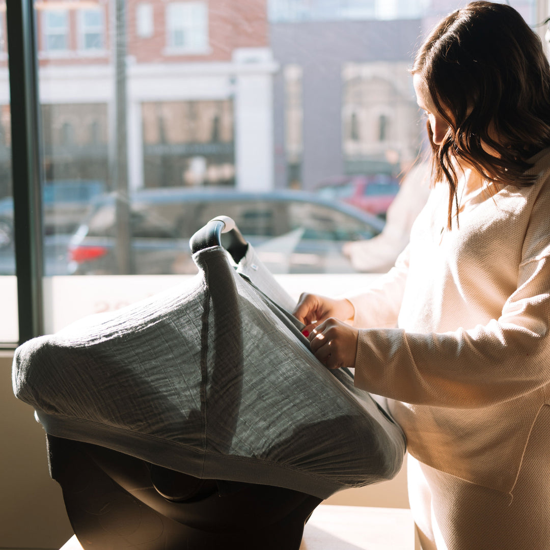 Beautiful ocean-inspired tone featured on the Little Unicorn Cotton Muslin Car Seat Canopy - Sea, a must-have car seat accessory.