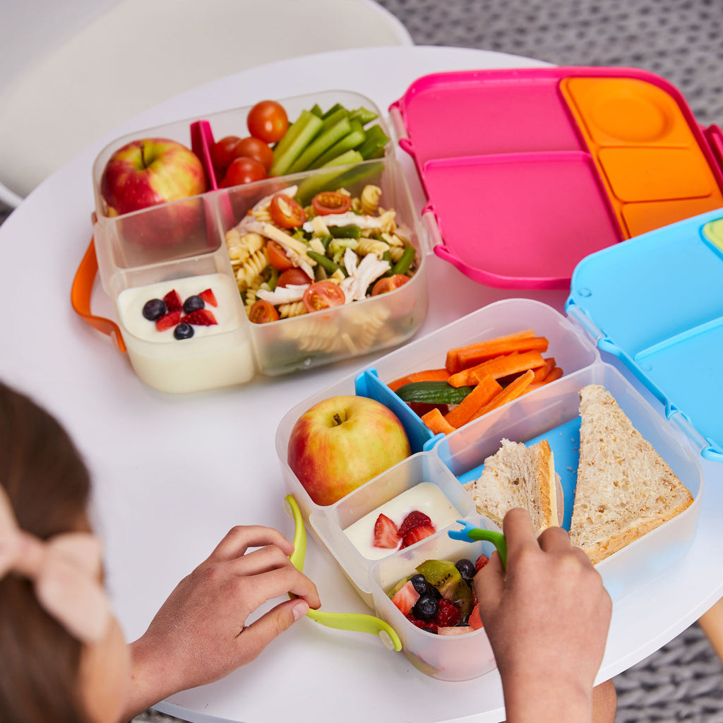 children eating from two jumbo bento boxes by b.box in strawberry and ocean