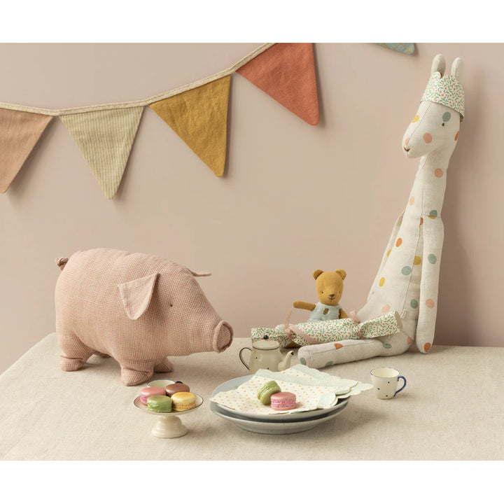 A sweet Maileg Polly Pork is shown ready for cuddles, making it a delightful stuffed animal companion.