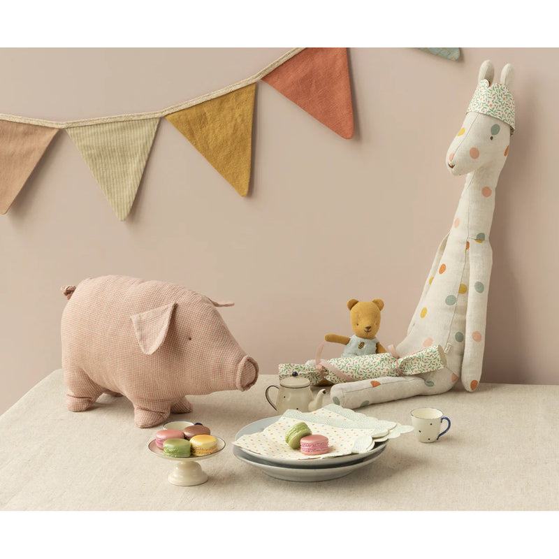 A sweet Maileg Polly Pork is shown ready for cuddles, making it a delightful stuffed animal companion.