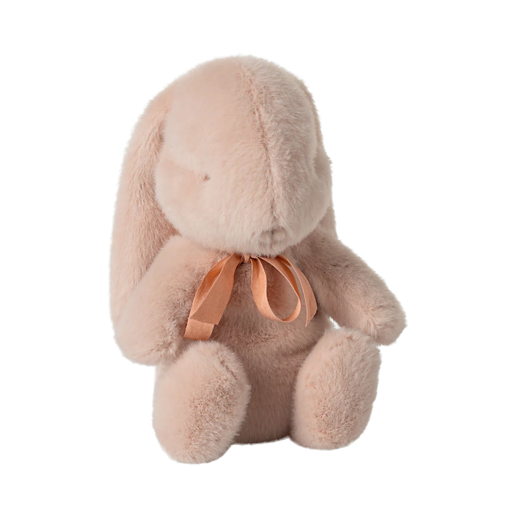 soft plush powder pink bunny rabbit toy with orange bow against white background