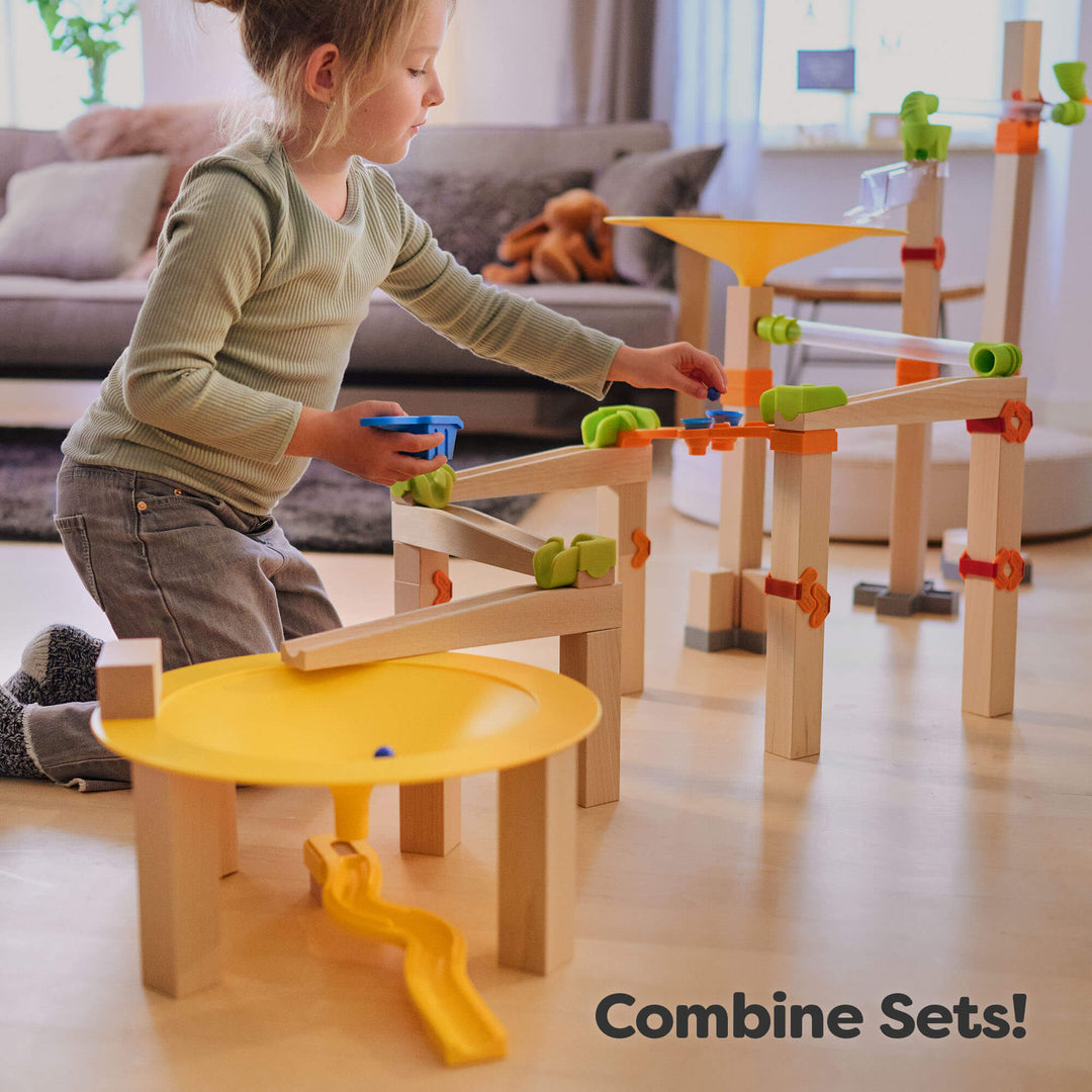Stack, roll, and design tracks with HABA Marble Run Funnel Jungle Starter Set, a colorful wood toy for toddlers.