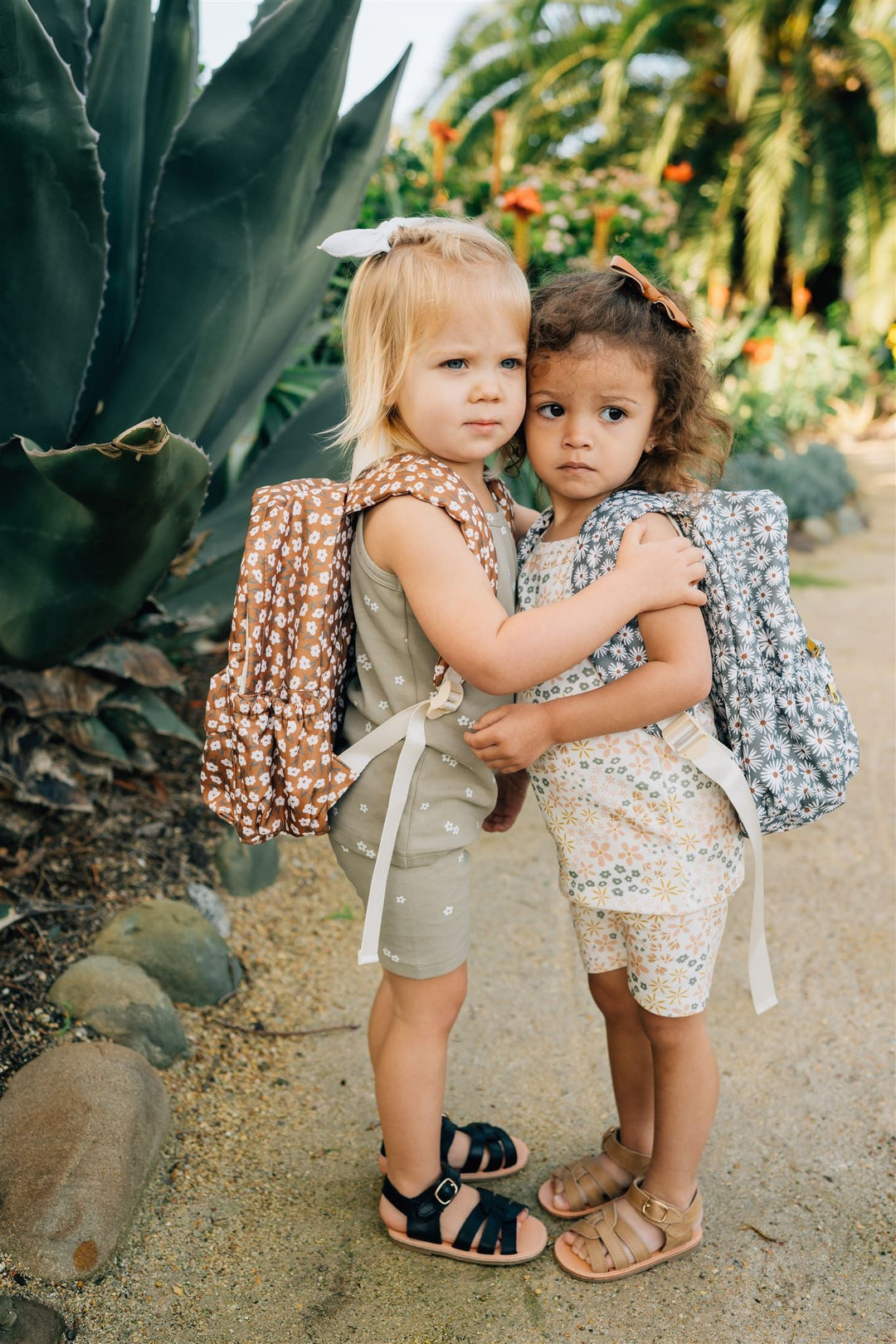 Close-up of the Mebie Baby Green Daisy Mini Backpack, featuring floral details on this stylish backpacks for kids
