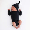 newborn wearing Kyte black baby hat  