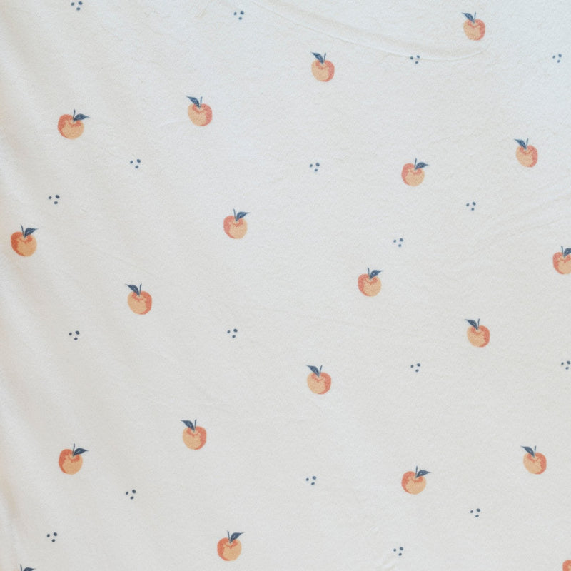 Built for newborn snuggle success, the Saranoni Minky Stretch Luxe Swaddle/Blanket in Apple also doubles as a swaddle.