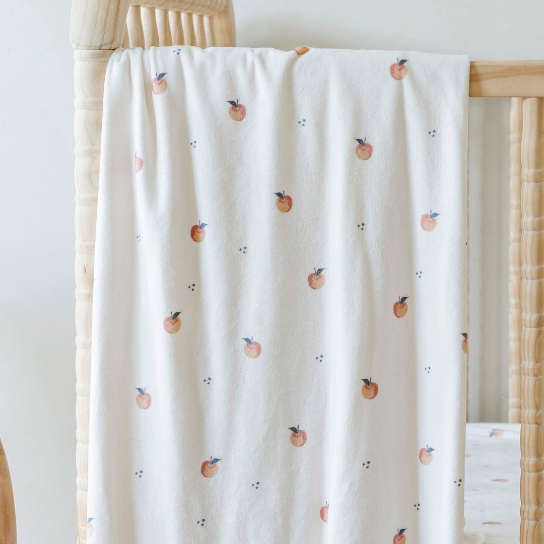 Saranoni Minky Stretch Luxe Swaddle/Blanket in Apple supports secure wrapping and works beautifully as a baby swaddle.